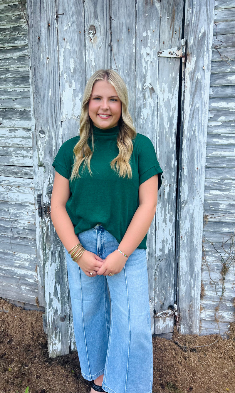 Solid short sleeve mock neck top featuring rolled cuffs