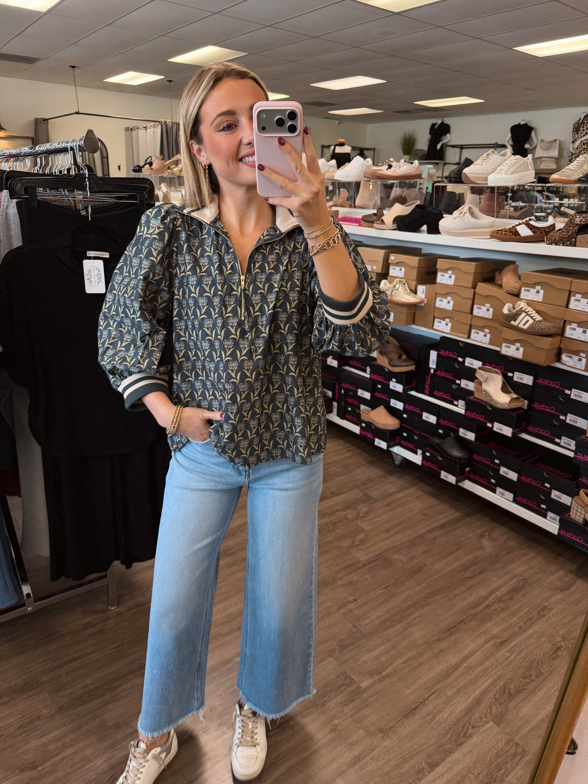 Floral print 3/4 puff sleeve top featuring half zip closure at front