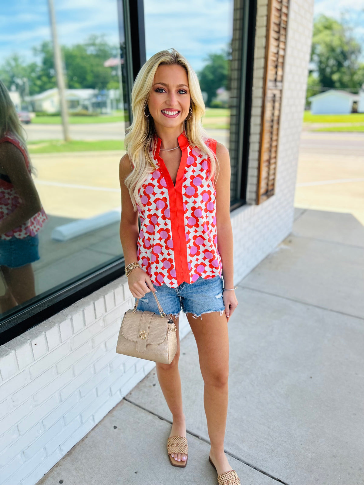 Printed sleeveless top featuring scallop hem detail.