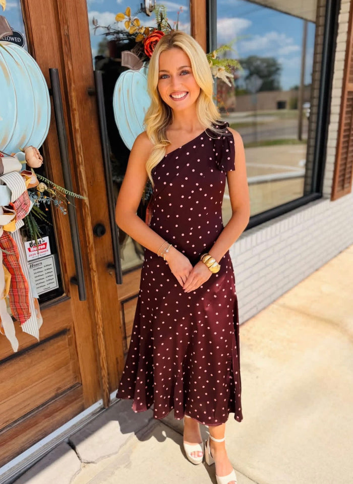 Silky satin midi dress featuring a one-shoulder neckline with oversized bow detail