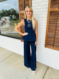 Solid sleeveless top featuring peplum hem
