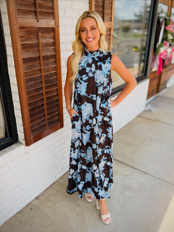 Floral print sleeveless maxi dress featuring mock neck detail.