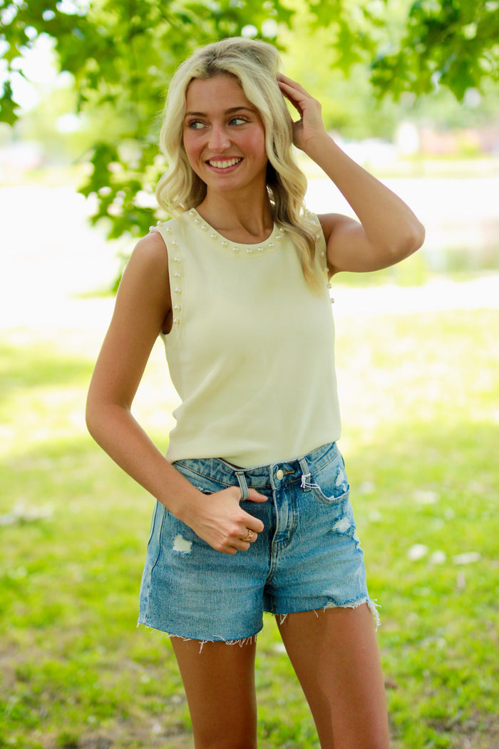 Solid round neck sleeveless cropped top featuring pearl detail