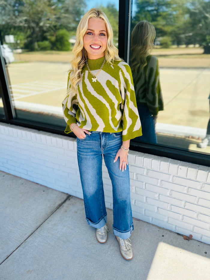 Abstract print ¾ sleeve sweater top with a mock neck