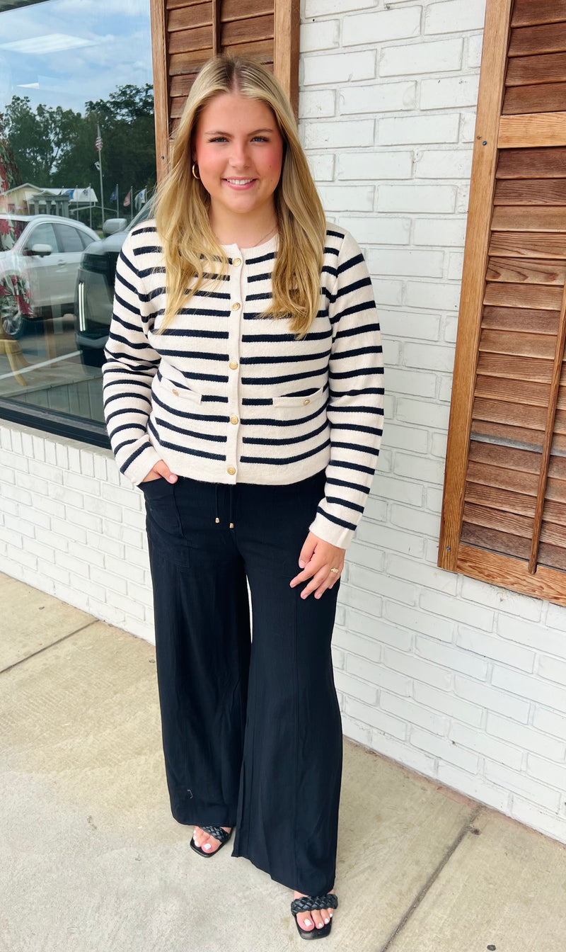 Stripe pattern long sleeve cardigan featuring gold accent button closure at front.