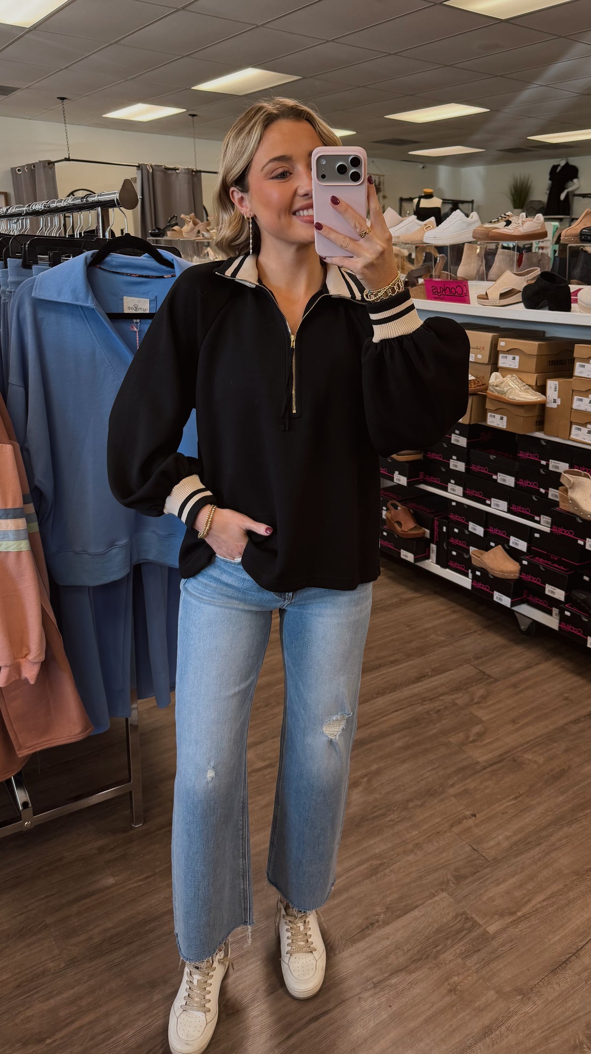 Solid long sleeve knit top featuring half zip closure at front and striped ribbed collar