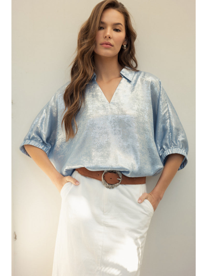 Metallic top with open collared neck, Half dolman sleeves, and stretch-band cuffs.
