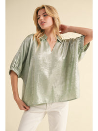 Metallic top with open collared neck, Half dolman sleeves, and stretch-band cuffs.