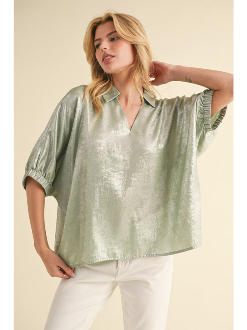 Metallic top with open collared neck, Half dolman sleeves, and stretch-band cuffs.