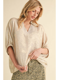 Metallic top with open collared neck, Half dolman sleeves, and stretch-band cuffs.