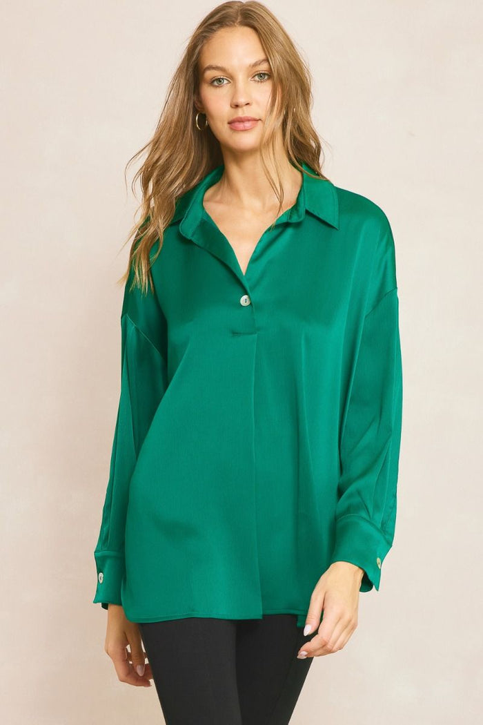 Solid collared long sleeve top featuring button detail at front and cuff