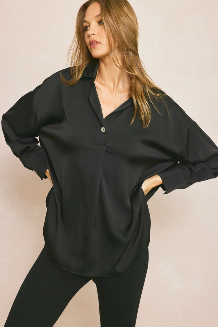 Solid collared long sleeve top featuring button detail at front and cuff