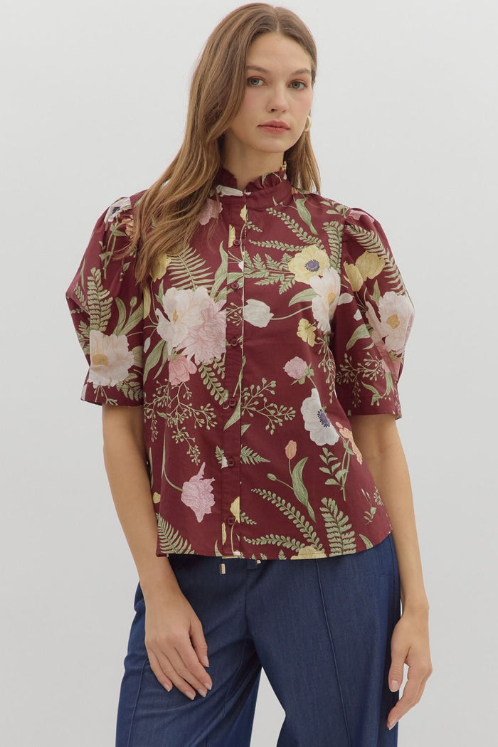 Floral print ruffled neck button front closure featuring pleated short puff sleeve.