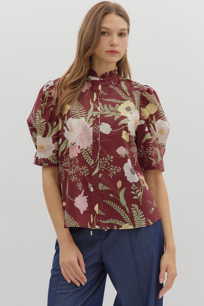 Floral print ruffled neck button front closure featuring pleated short puff sleeve.