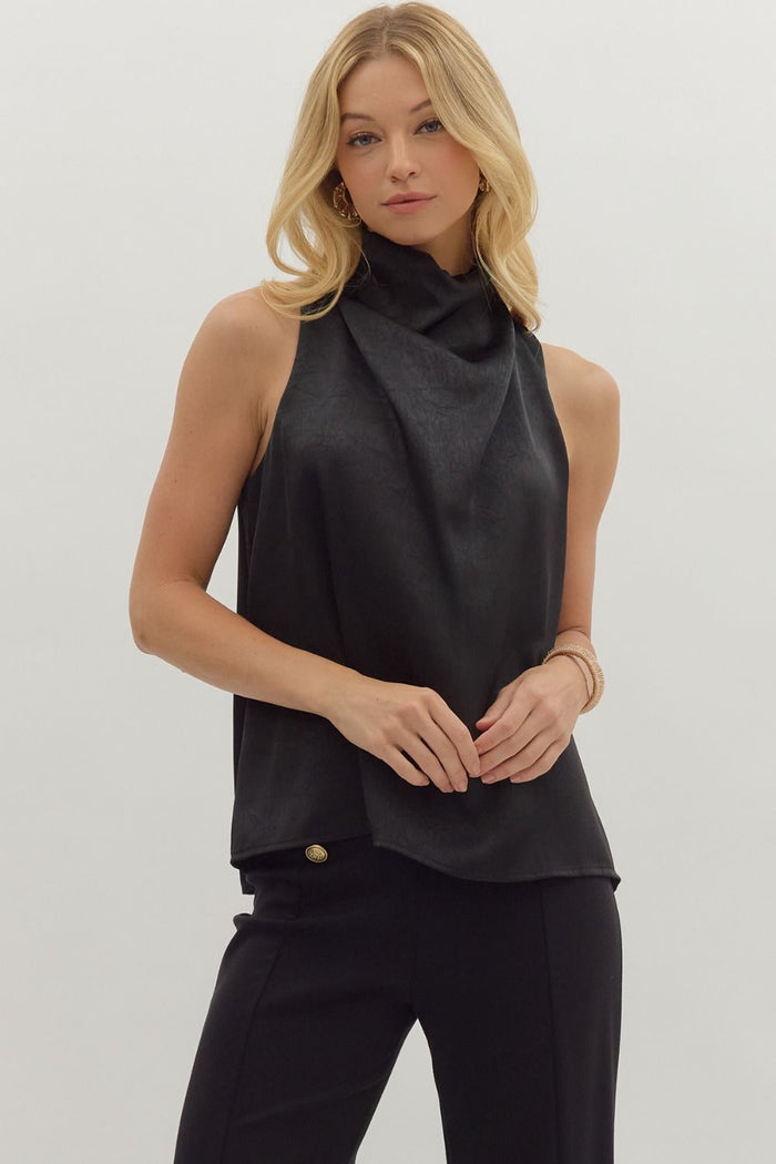 Solid sleeveless mock neck top featuring draped front