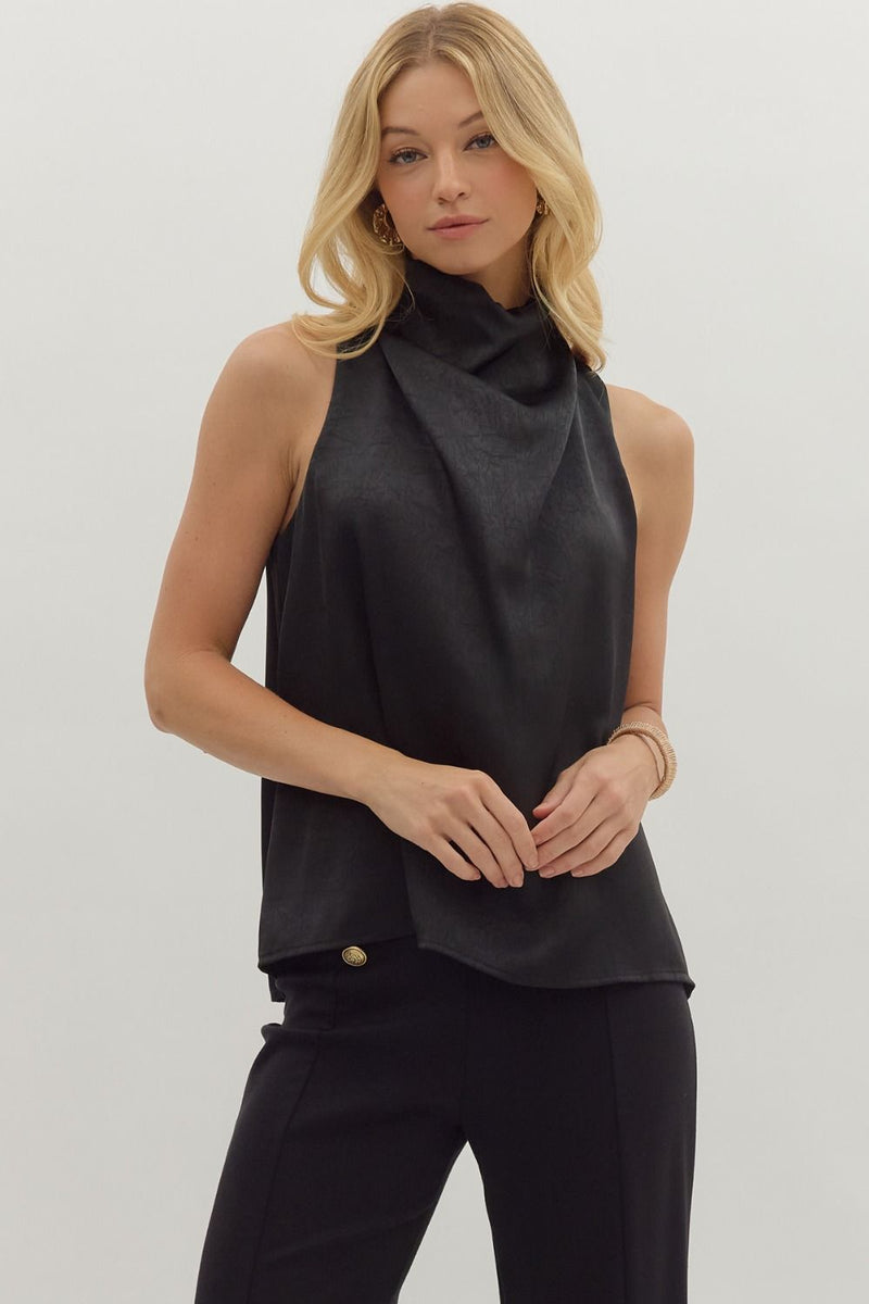 Solid sleeveless mock neck top featuring draped front