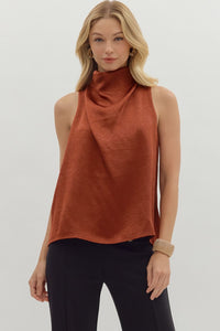Solid sleeveless mock neck top featuring draped front