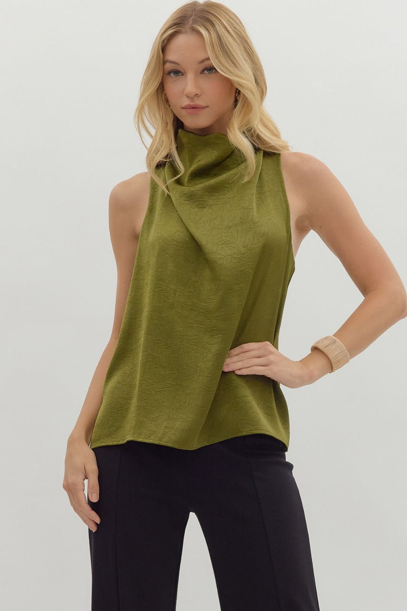 Solid sleeveless mock neck top featuring draped front