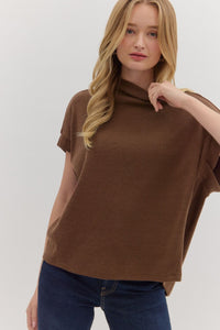 Solid short sleeve mock neck top featuring rolled cuffs