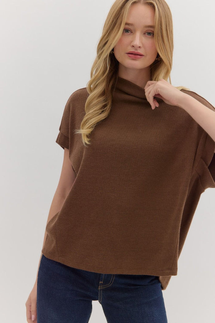 Solid short sleeve mock neck top featuring rolled cuffs