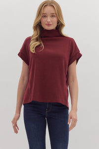 Solid short sleeve mock neck top featuring rolled cuffs