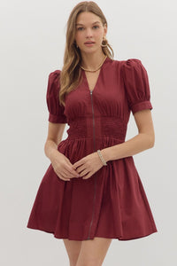 Solid short puff sleeve V-neck mini dress featuring smocked waist front-zip closure.