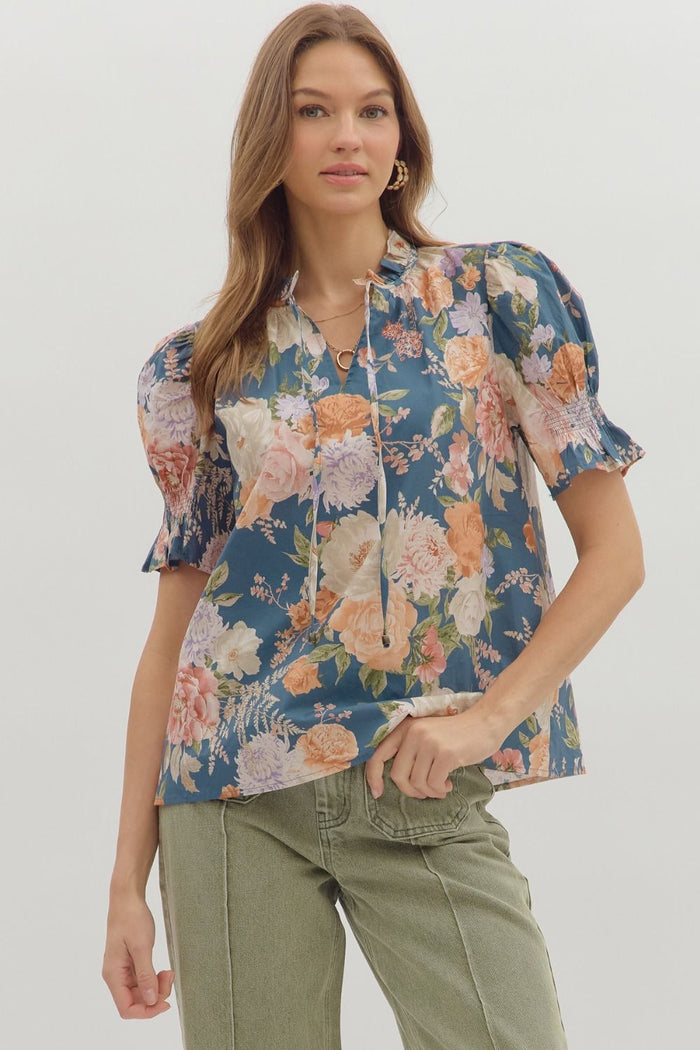 Floral print smocked short puff sleeve ruffle finish V-neck top.