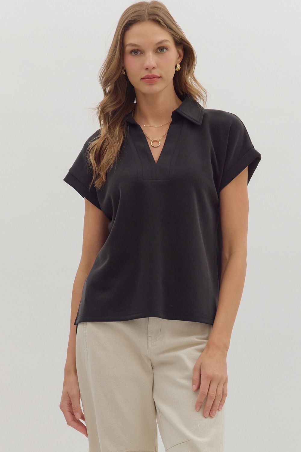 Solid cuffed short sleeve top featuring collared V-neck.