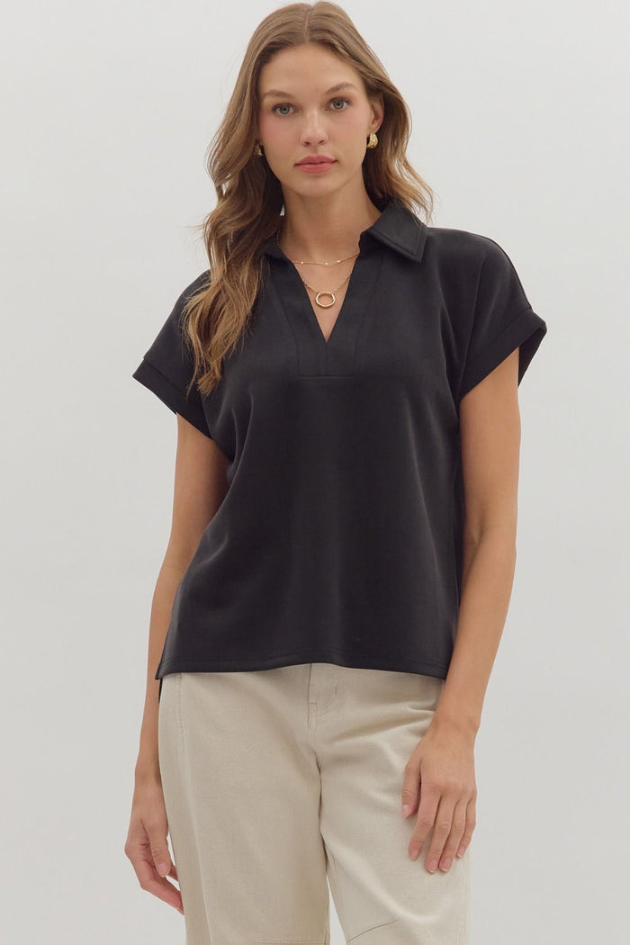 Solid cuffed short sleeve top featuring collared V-neck.
