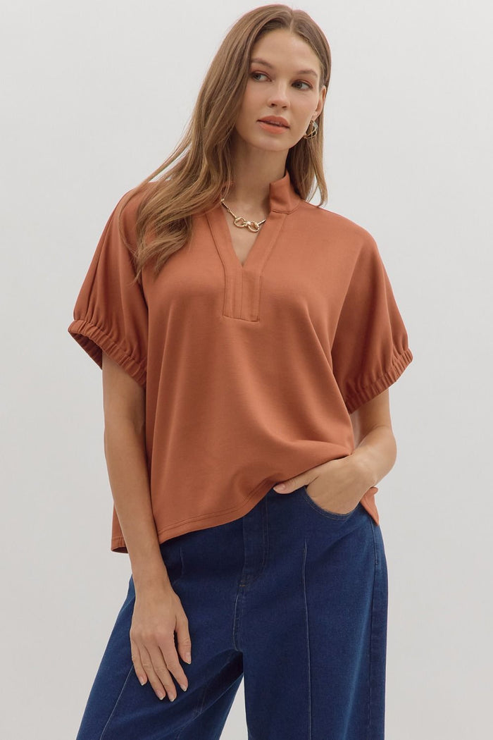 Solid short sleeve top featuring split V-neck with collar band