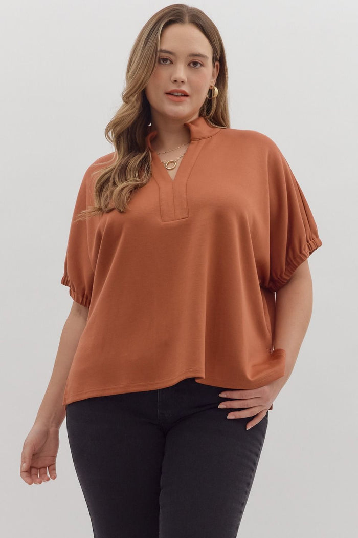 Solid short sleeve top featuring split V-neck with collar band