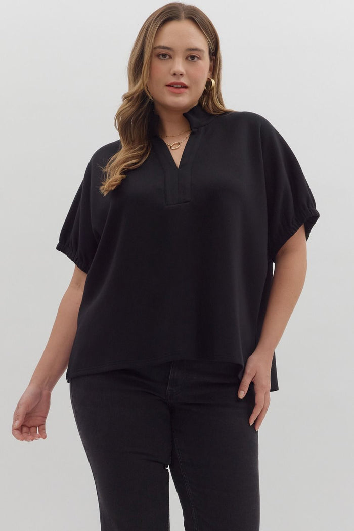 Solid short sleeve top featuring split V-neck with collar band