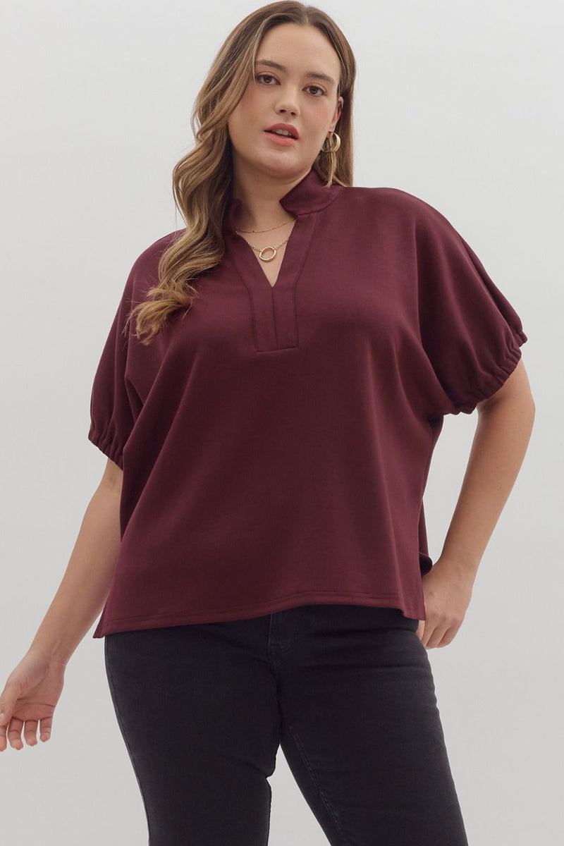 Solid short sleeve top featuring split V-neck with collar band