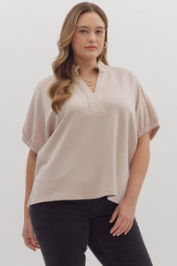 Solid short sleeve top featuring split V-neck with collar band