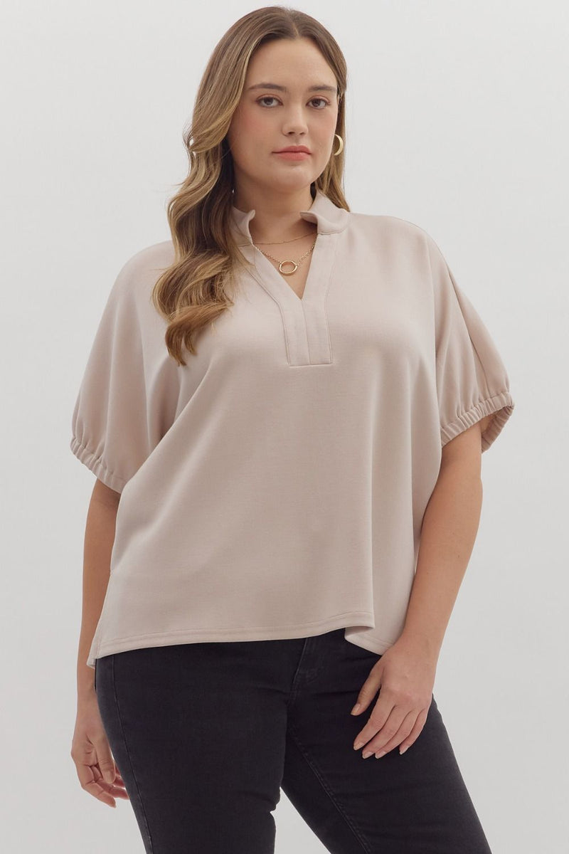 Solid short sleeve top featuring split V-neck with collar band