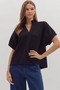 Solid short sleeve top featuring split V-neck with collar band