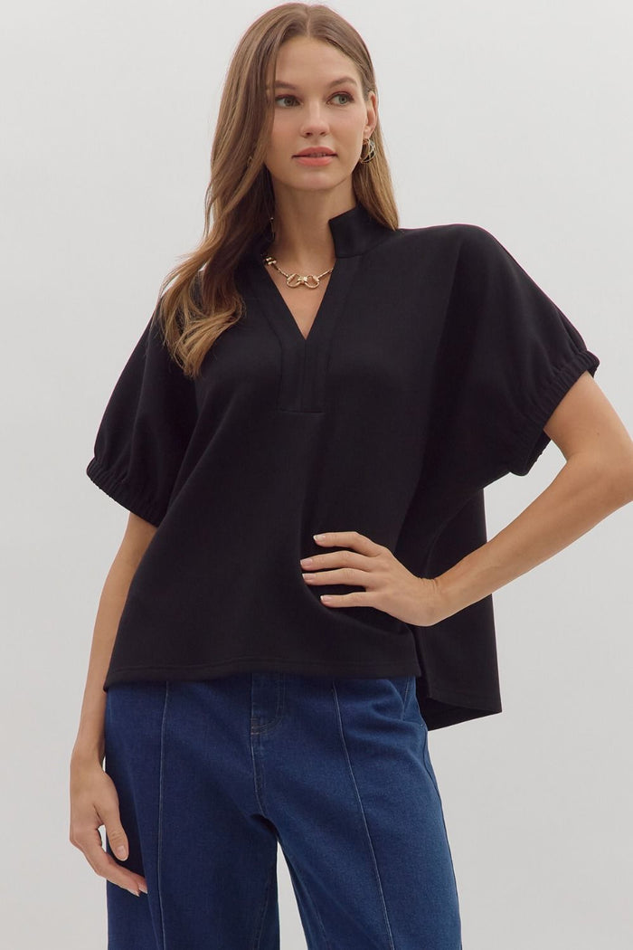 Solid short sleeve top featuring split V-neck with collar band