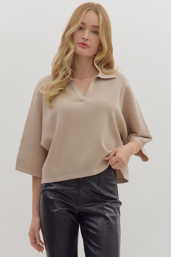 Solid 3/4 sleeve knit top featuring open V-neck collar
