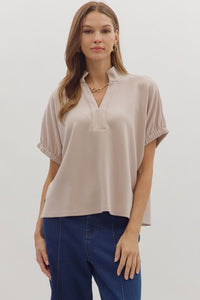 Solid short sleeve top featuring split V-neck with collar band