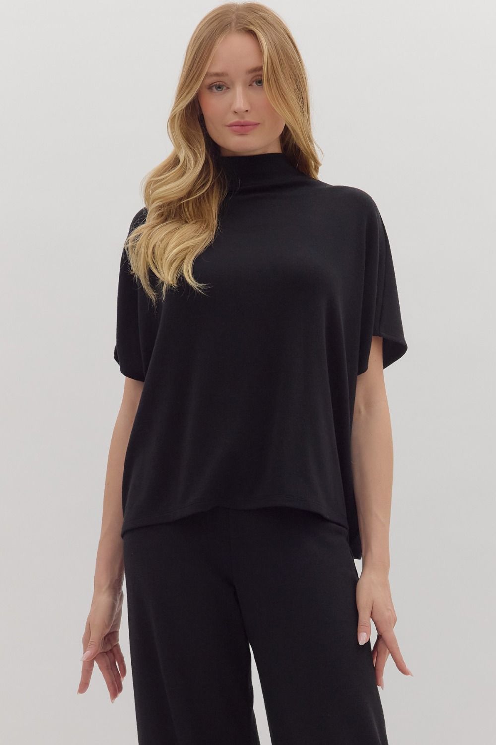 Solid short sleeve pullover top featuring mock neck