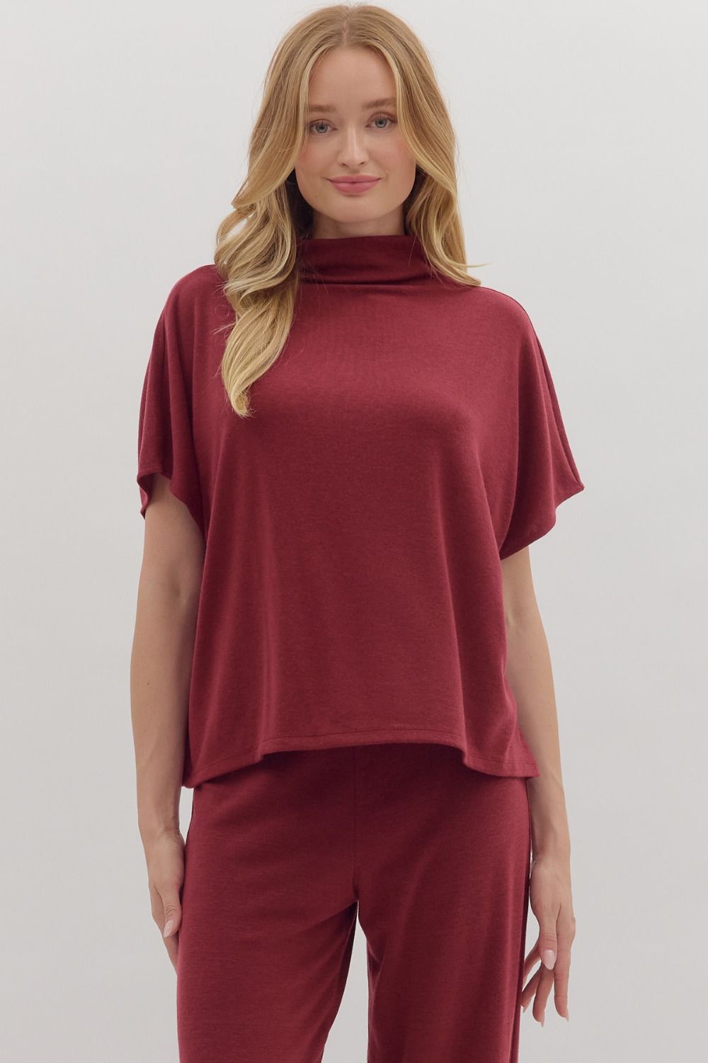Solid short sleeve pullover top featuring mock neck