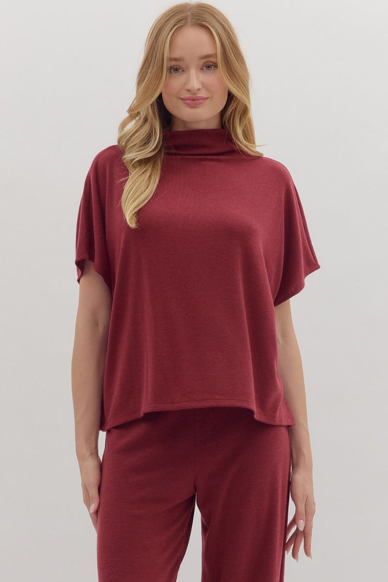 Solid short sleeve pullover top featuring mock neck