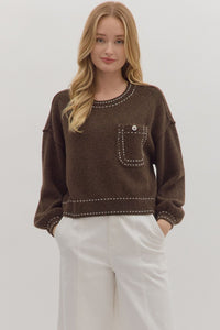 Solid long sleeve sweater knit top featuring contrast blanket stitch accents