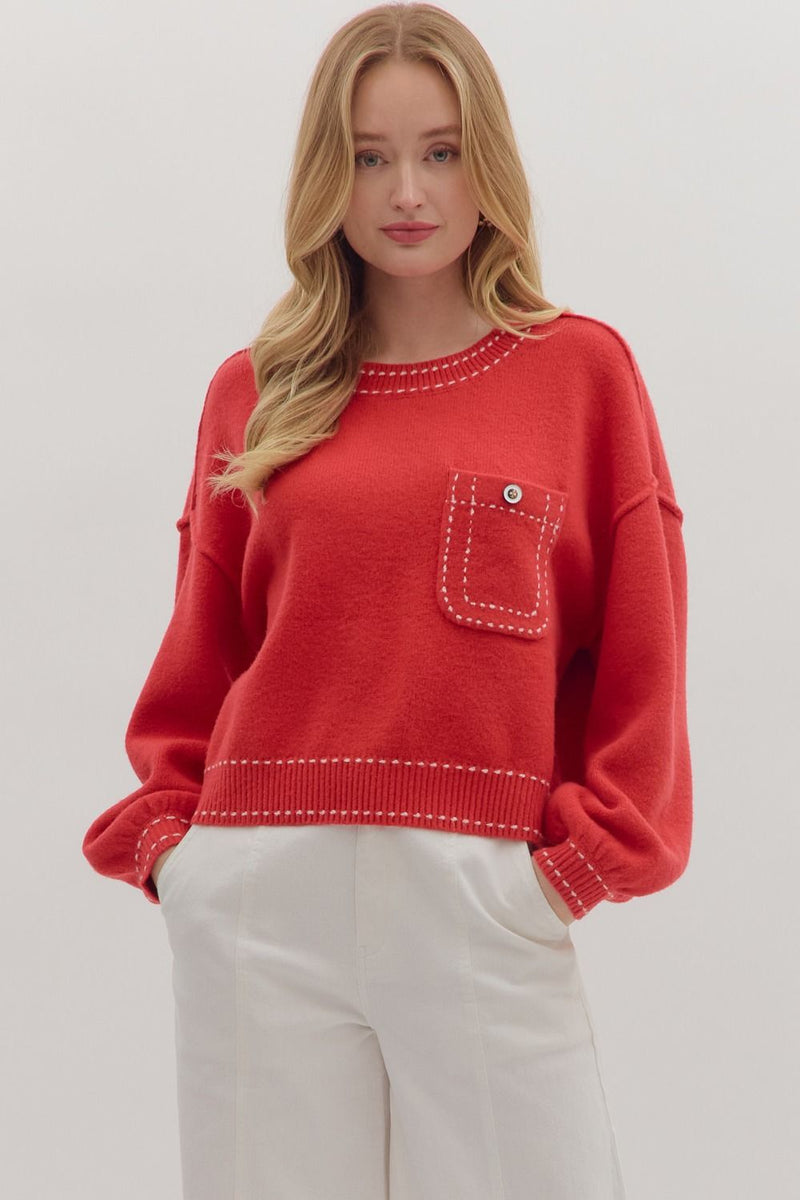 Solid long sleeve sweater knit top featuring contrast blanket stitch accents