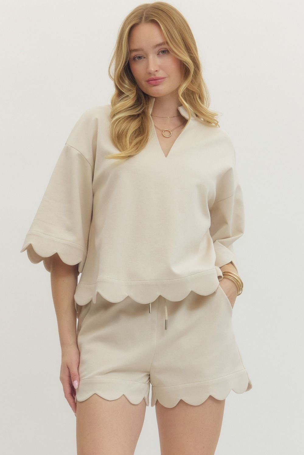 V-neck top featuring scallop accent
