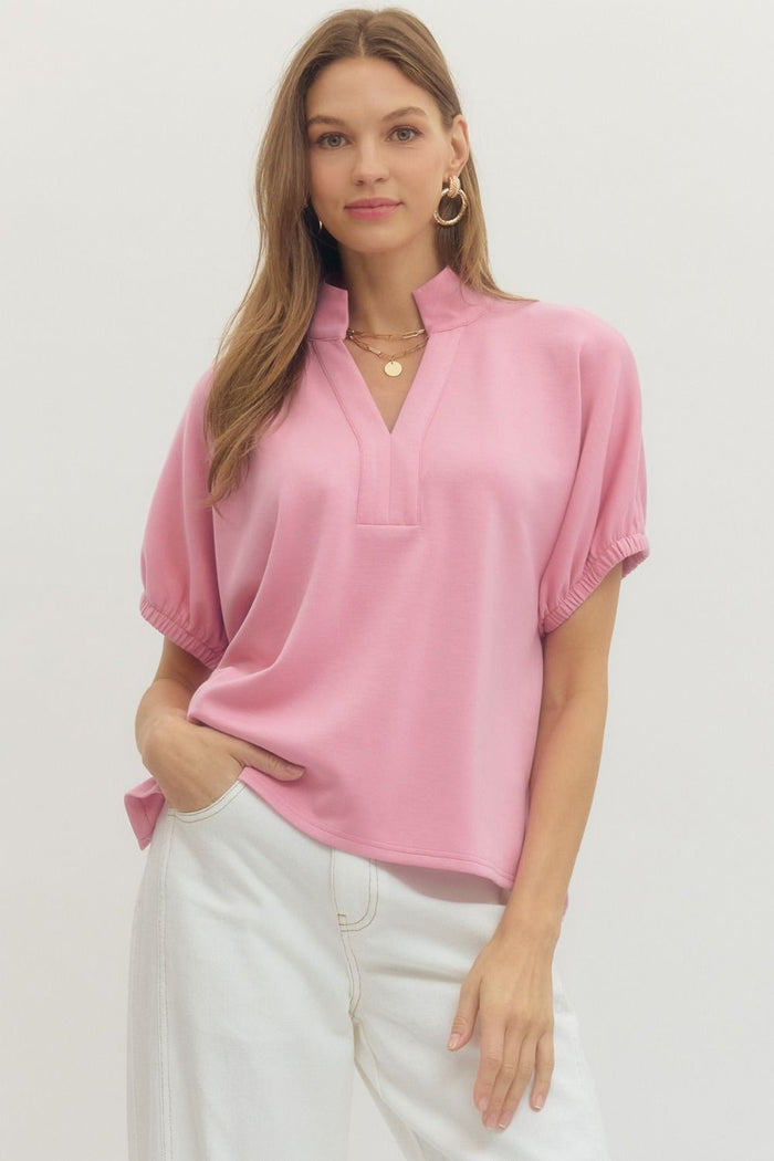 Solid short sleeve top featuring split V-neck with collar band