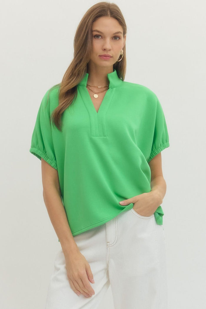 Solid short sleeve top featuring split V-neck with collar band