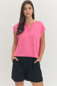 Solid short sleeve knit top featuring ribbed V-neck detail