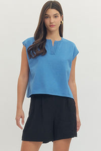 Solid short sleeve knit top featuring ribbed V-neck detail