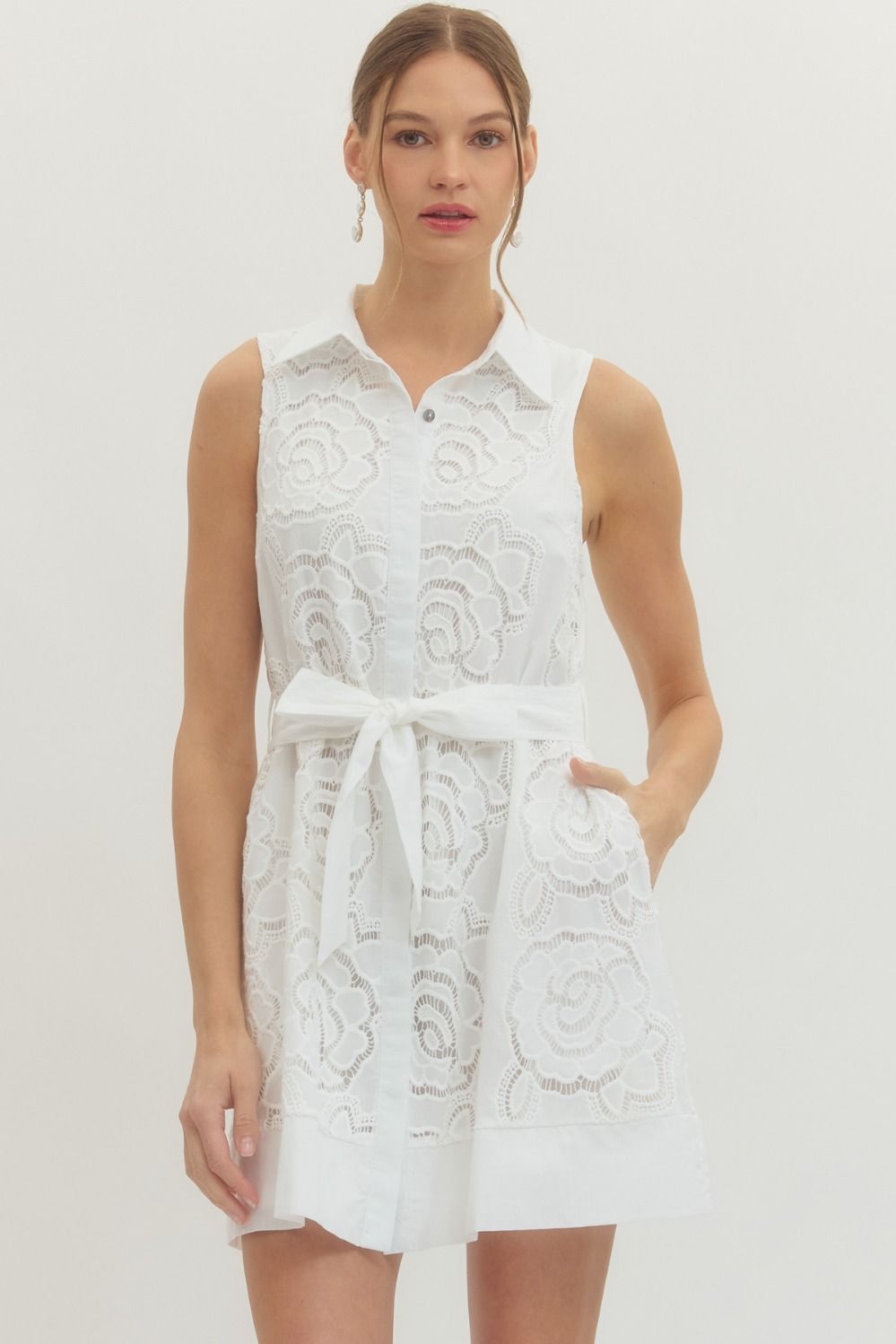 Solid sleeveless mini dress featuring floral lace overlay